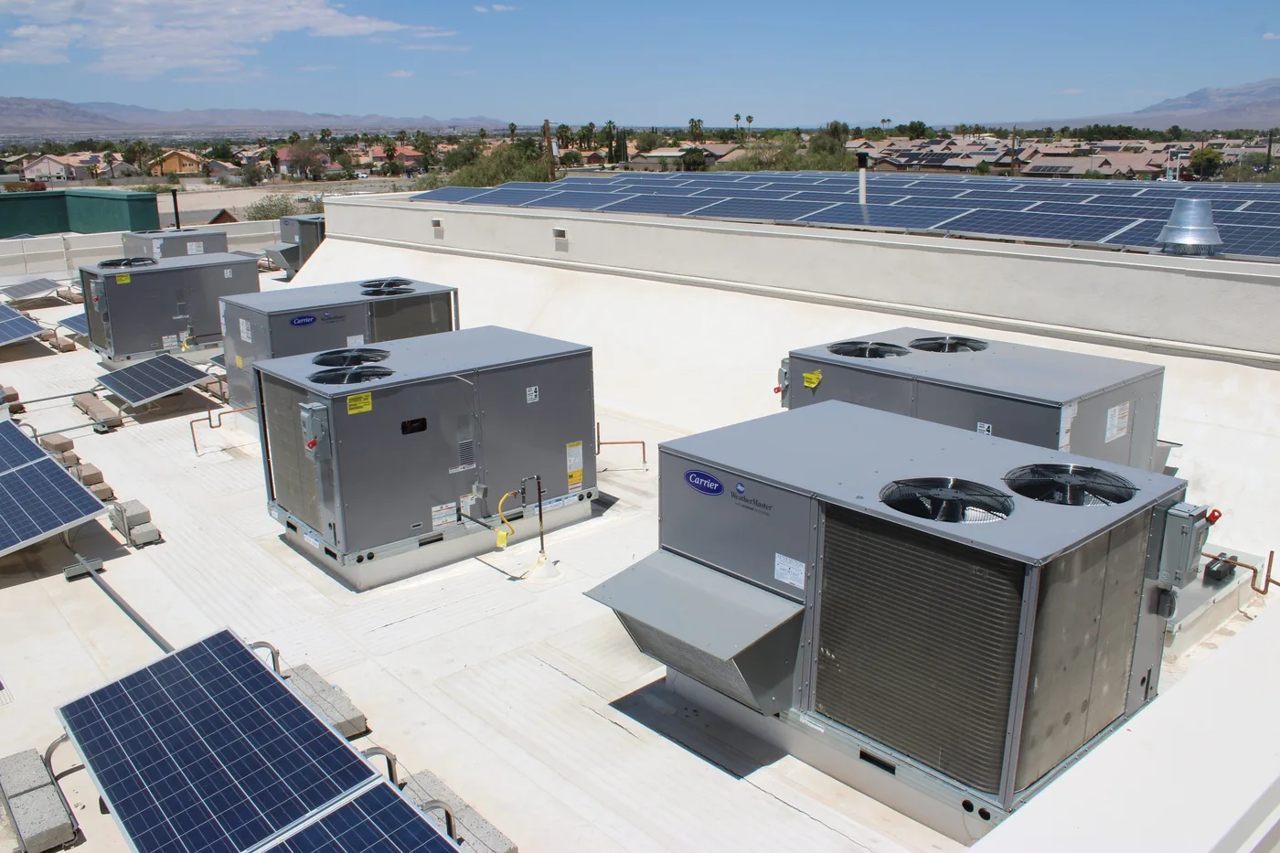Commercial rooftop unit being lifted into position for retrofit replacement